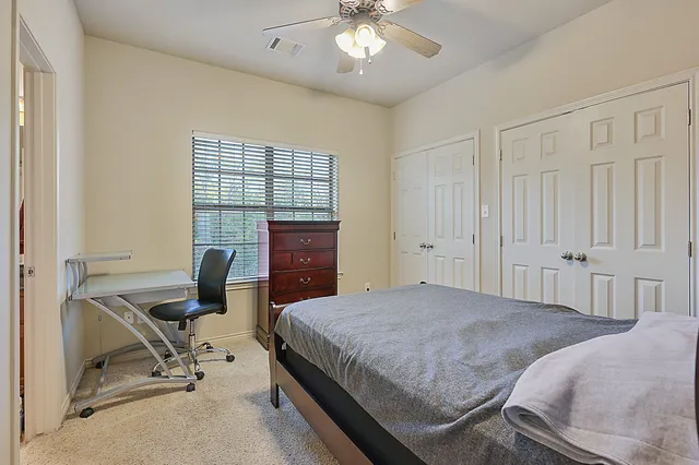 a bedroom with a bed and a desk