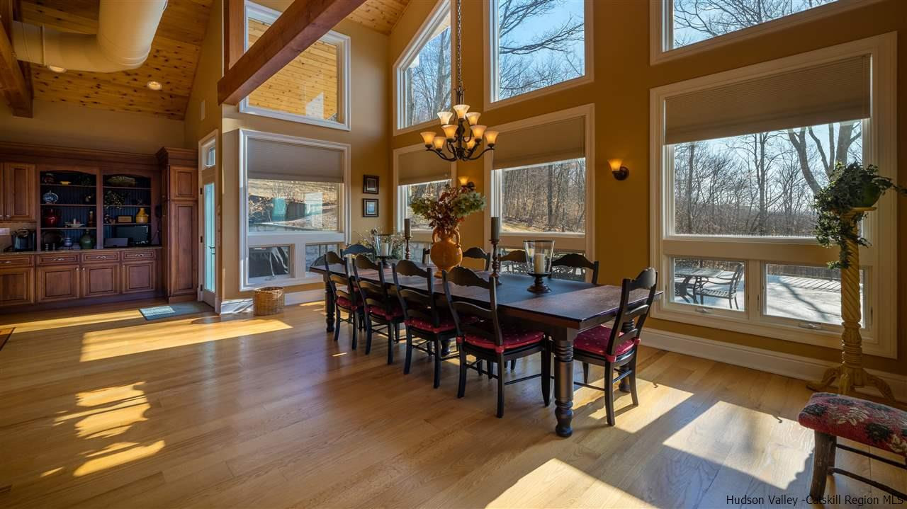 374 Kristins Ridge Road Margaretville, NY 12455 - Photo 11 of 33 a view of a dining room with furniture window and wooden floor