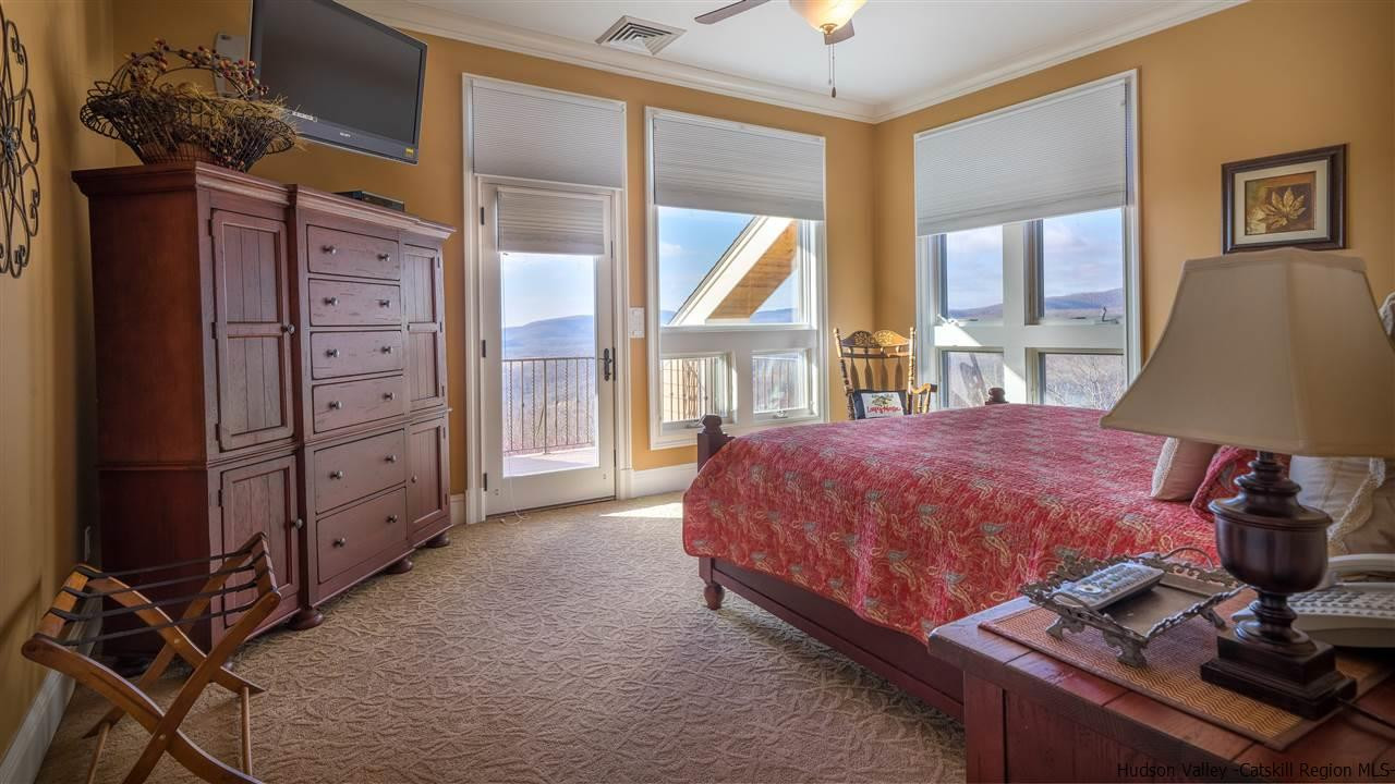 374 Kristins Ridge Road Margaretville, NY 12455 - Photo 15 of 33 a spacious bedroom with a bed and a window