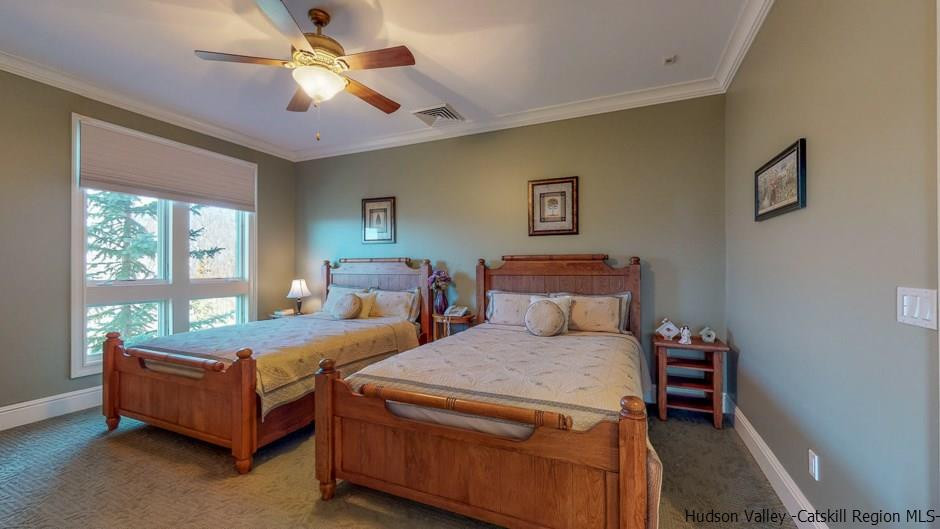 374 Kristins Ridge Road Margaretville, NY 12455 - Photo 22 of 33 a bedroom with a bed and a chandelier