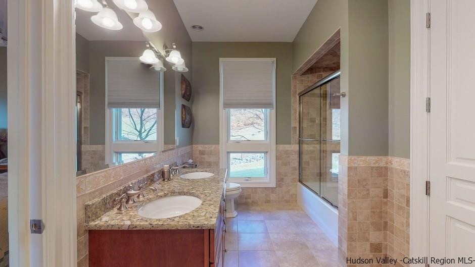 374 Kristins Ridge Road Margaretville, NY 12455 - Photo 24 of 33 a bathroom with a granite countertop sink and a mirror