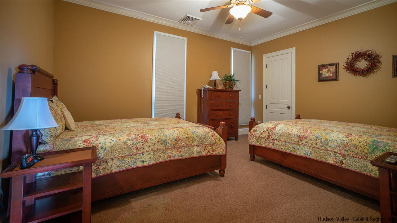 374 Kristins Ridge Road Margaretville, NY 12455 - Photo 27 of 33 a bedroom with a bed and a chandelier