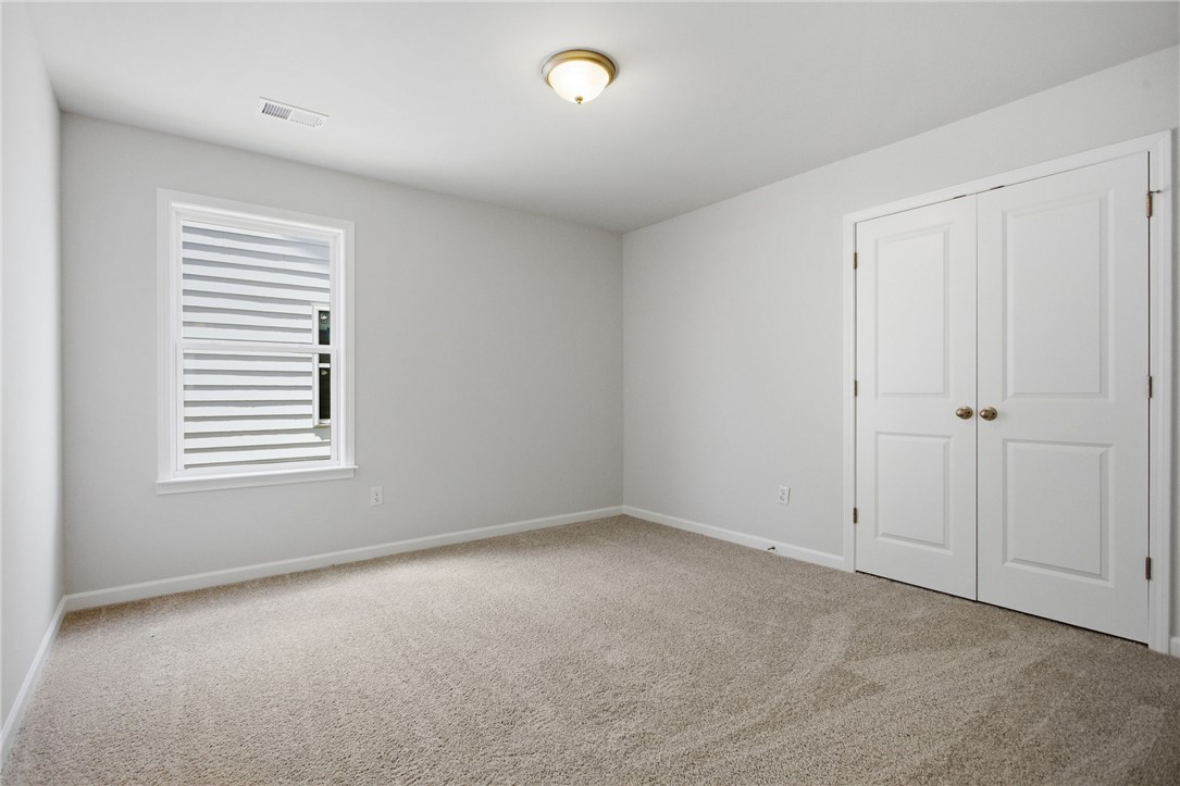 557 Hydrangea Street, Unit LOT 46 Seneca, SC 29678 - Photo 27 of 37 A well-lit bedroom offering a neutral palette, ready for personalization.