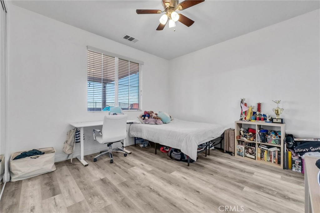 18388 Hidden Ranch Road Riverside, CA 92508 - Photo 23 of 46 a spacious bedroom with a bed and a table in it