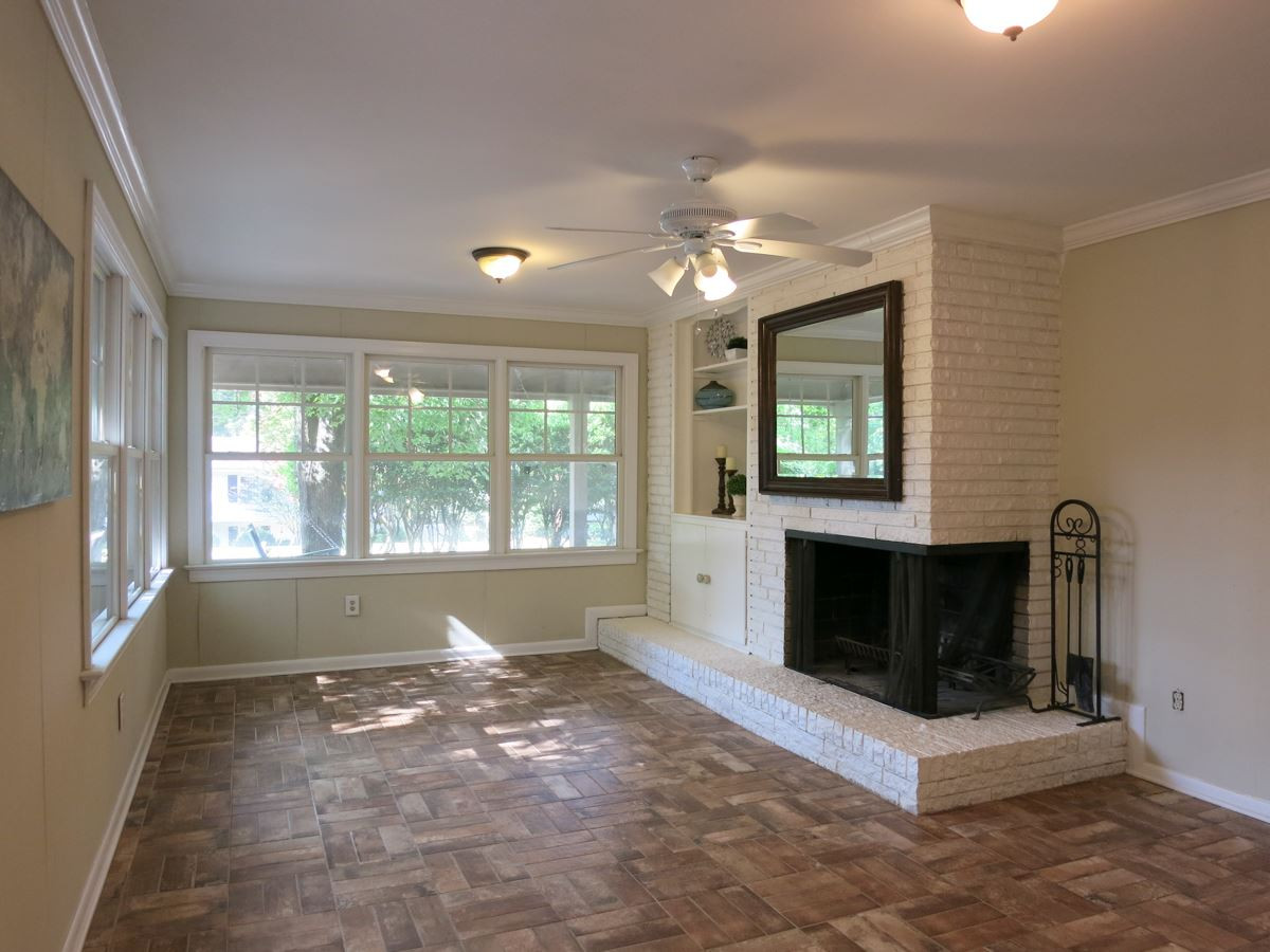 704 Currituck Drive Raleigh, NC 27609 - Photo 7 of 25 Through the Dining Rm is the big Family Rm w/wood burning brick FP, many windows, brick paver floor, CF, deep closet & built-in cabinetry. Family Room