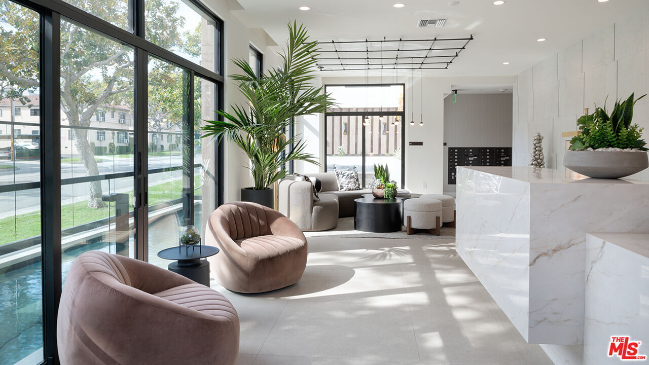 425 North Palm Drive, Unit 401 Beverly Hills, CA 90210 - Photo 13 of 22 a living room with furniture and a potted plant