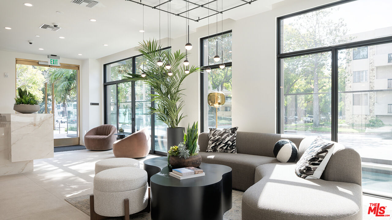 425 North Palm Drive, Unit 401 Beverly Hills, CA 90210 - Photo 14 of 22 a living room with furniture and a large window