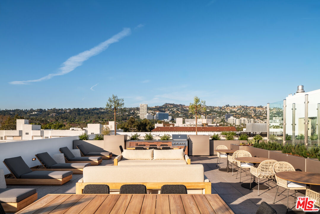 425 North Palm Drive, Unit 401 Beverly Hills, CA 90210 - Photo 20 of 22 a view of a terrace with lawn chairs