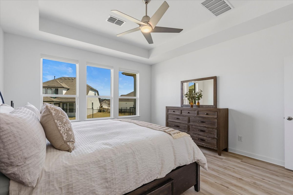 1904 Varese Path Leander, TX 78641 - Photo 16 of 40 a bedroom with a bed and a dresser