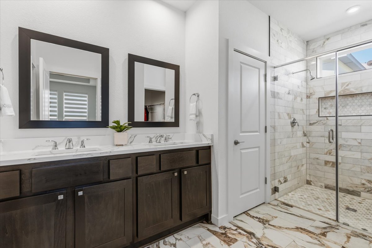 1904 Varese Path Leander, TX 78641 - Photo 17 of 40 a bathroom with a double vanity sink mirror and double