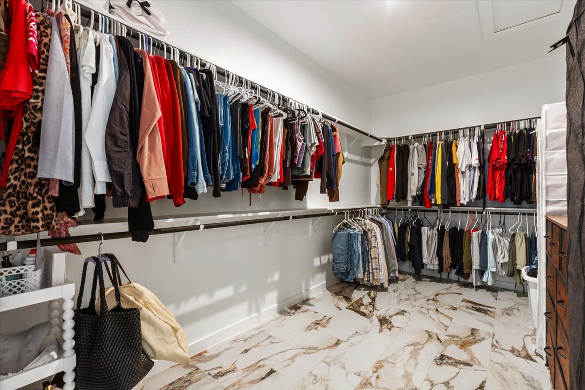 1904 Varese Path Leander, TX 78641 - Photo 19 of 40 a view of walk in closet with clothes and shoes