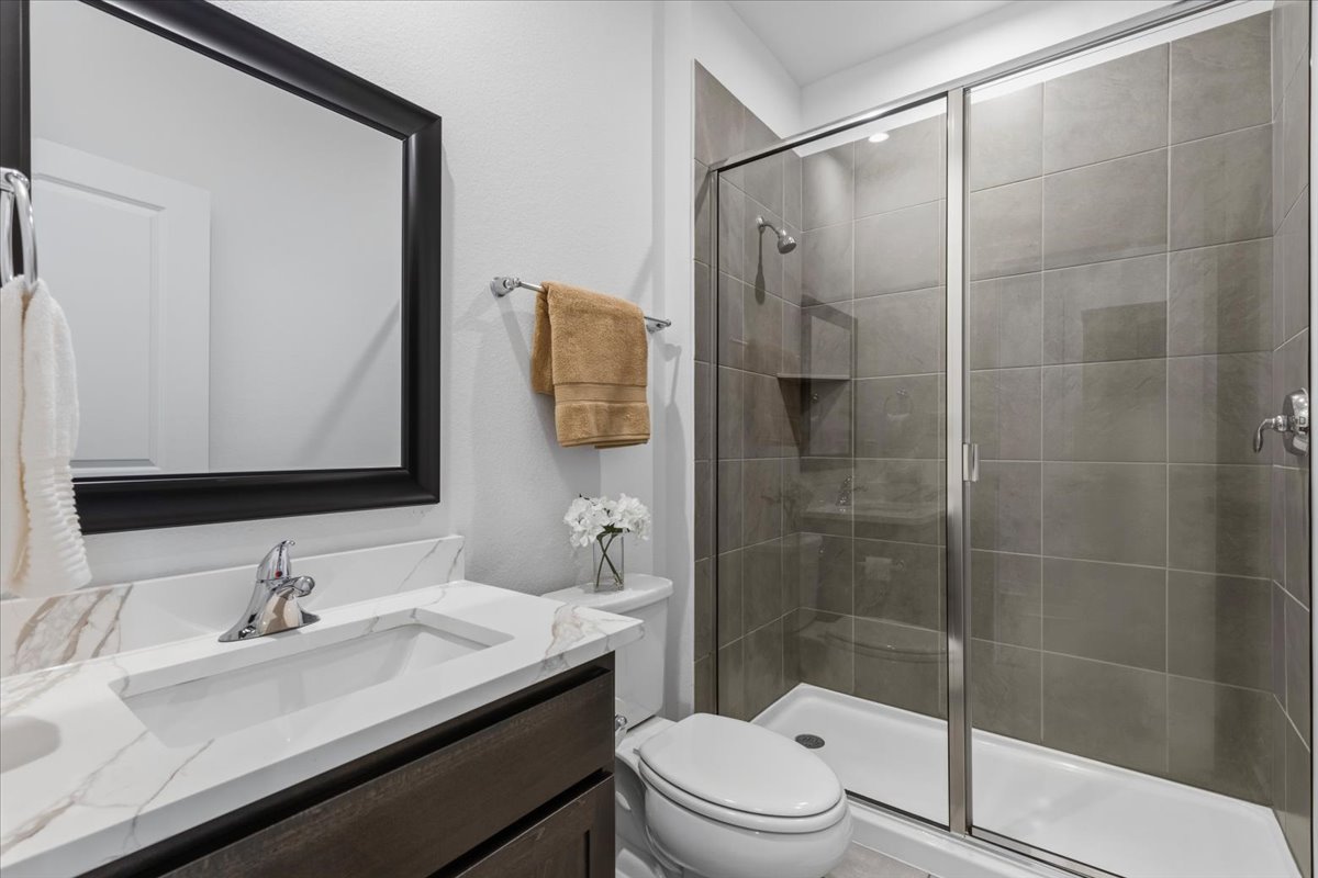 1904 Varese Path Leander, TX 78641 - Photo 22 of 40 a bathroom with a sink a toilet and shower