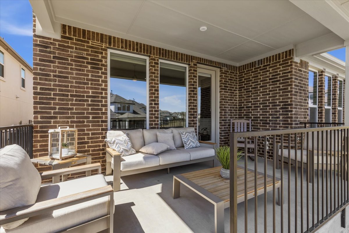 1904 Varese Path Leander, TX 78641 - Photo 31 of 40 a view of a patio with couches and a fire pit and wooden fence