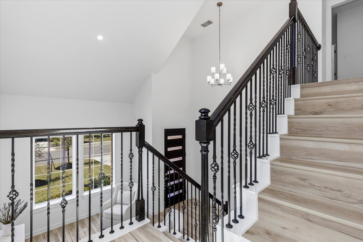 1904 Varese Path Leander, TX 78641 - Photo 5 of 40 a view of staircase with railing and white walls