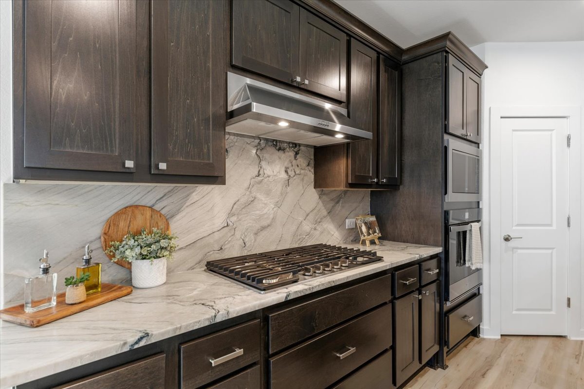 1904 Varese Path Leander, TX 78641 - Photo 9 of 40 a kitchen with a sink and cabinets