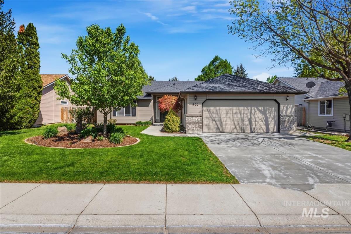 802 North Echohawk Way Eagle, ID 83616 - Photo 1 of 30 Single-story residence featuring a two-car garage, stone facade accents, and a well-maintained front lawn