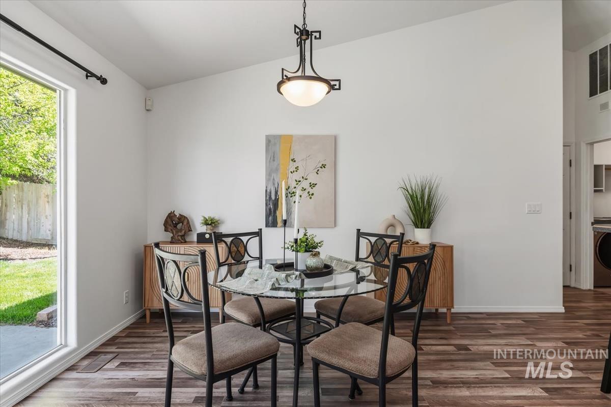 802 North Echohawk Way Eagle, ID 83616 - Photo 13 of 30 Vaulted white ceilings featuring a contemporary chandelier