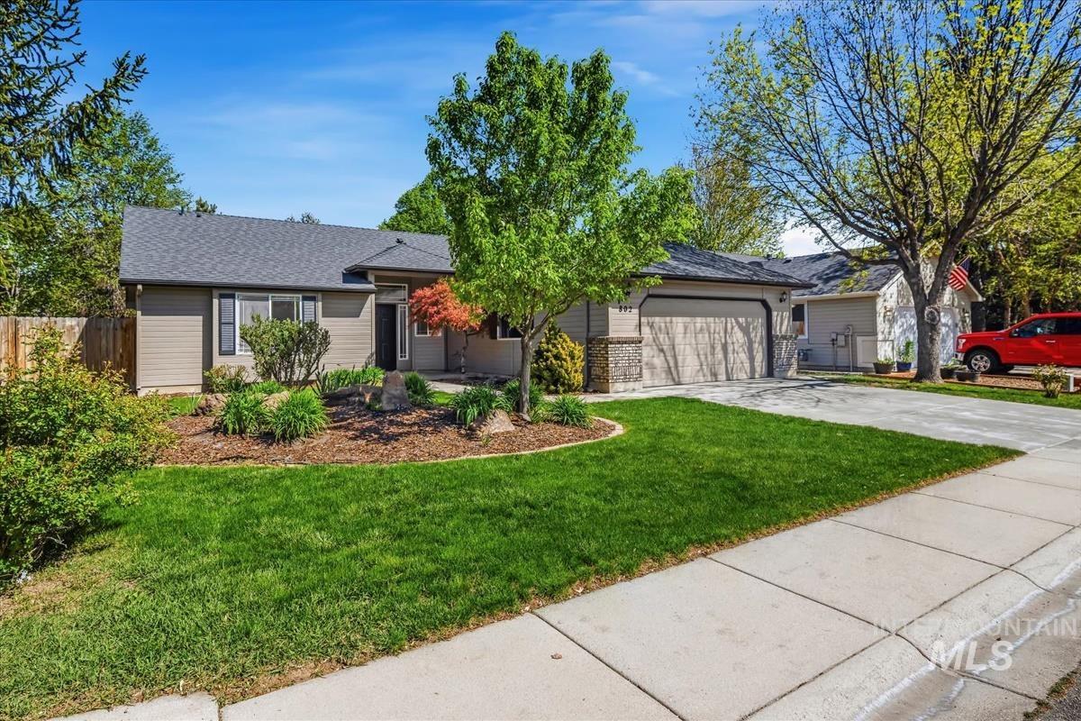 802 North Echohawk Way Eagle, ID 83616 - Photo 2 of 30 Single-story residence featuring a two-car garage, mature landscaping, and a concrete driveway