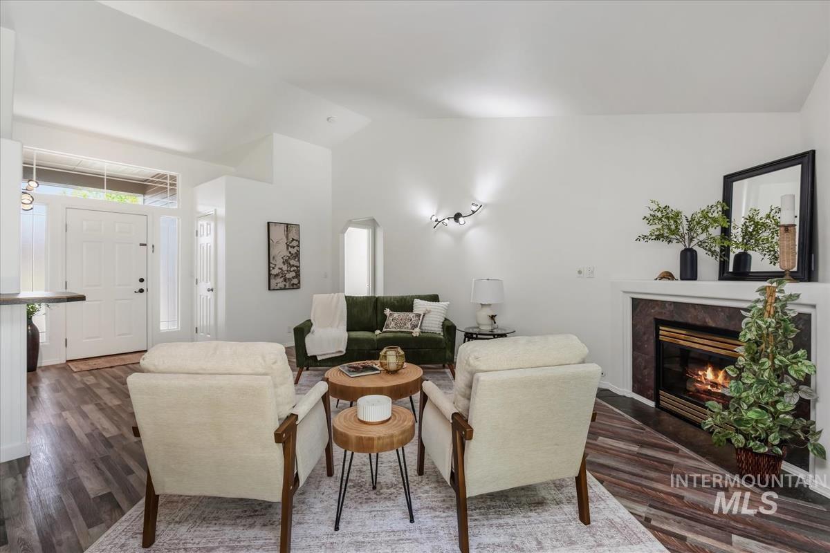 802 North Echohawk Way Eagle, ID 83616 - Photo 22 of 30 Vaulted ceilings complement the living area featuring a fireplace with a stone surround and white mantel