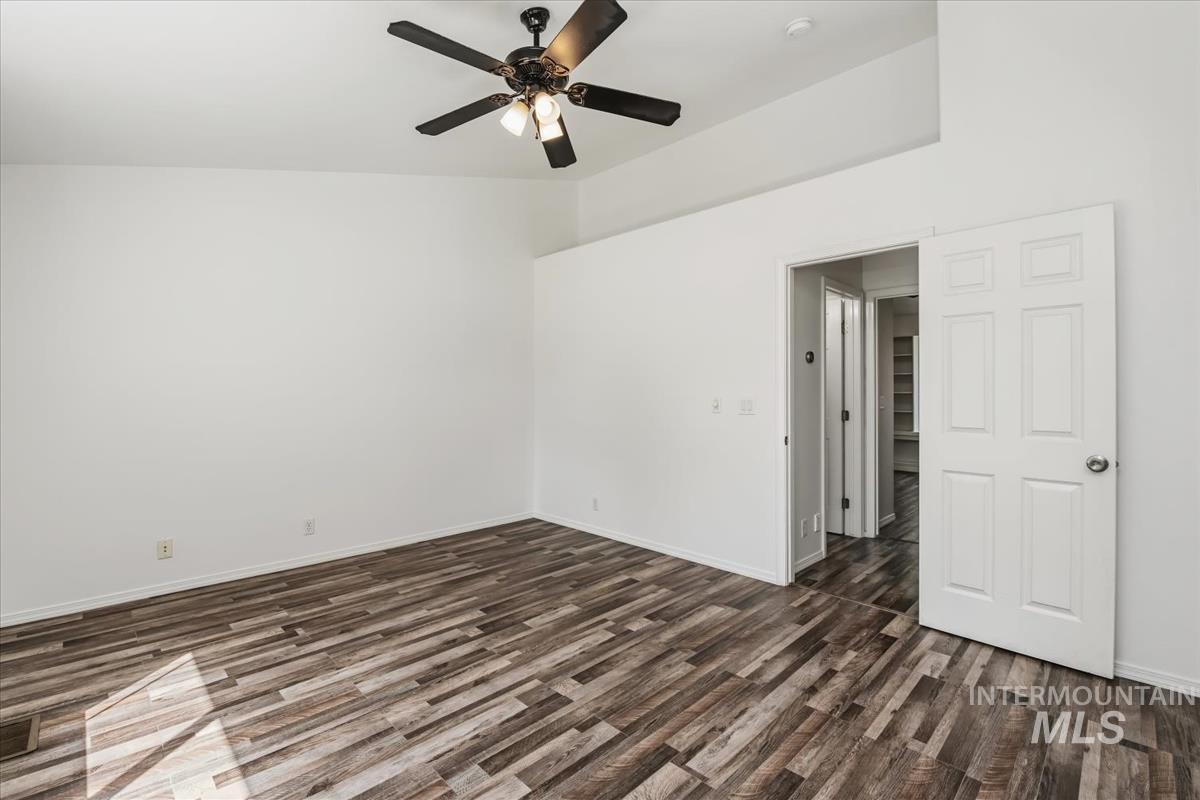 802 North Echohawk Way Eagle, ID 83616 - Photo 23 of 30 Spacious room featuring vaulted ceilings, wood-finish flooring, a ceiling fan with integrated lighting, and a paneled interior door