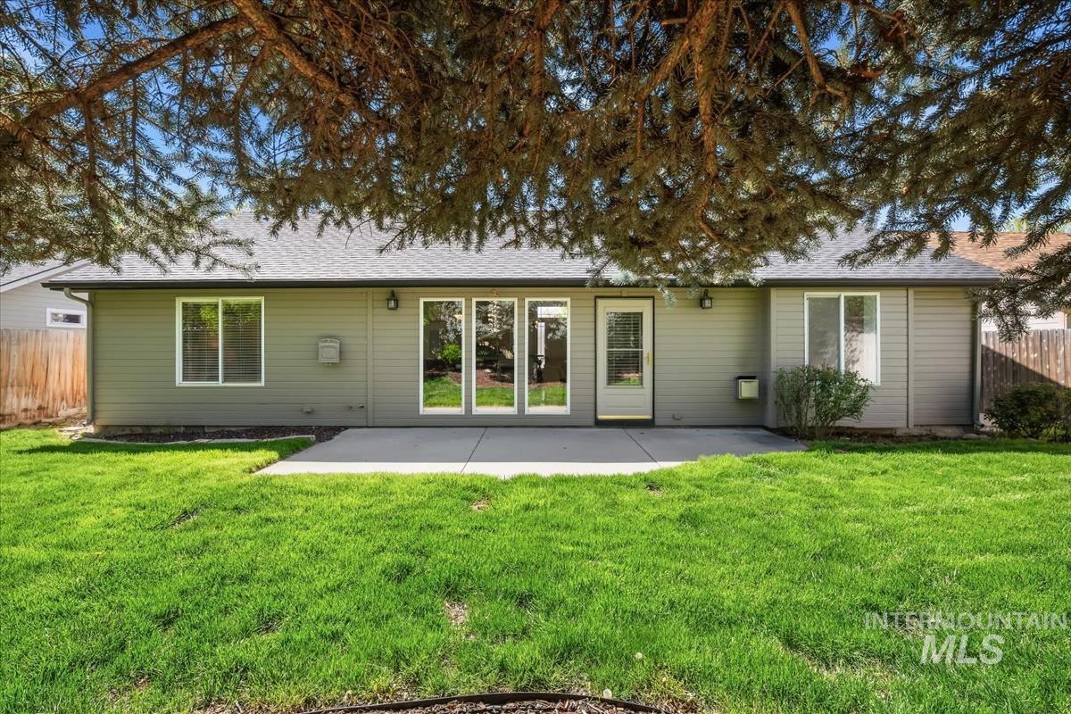 802 North Echohawk Way Eagle, ID 83616 - Photo 29 of 30 Rear exterior featuring a concrete patio, multiple windows, and a sliding glass door
