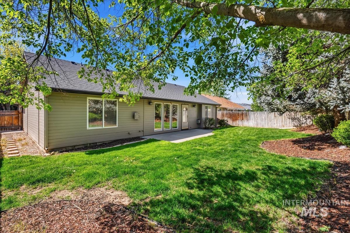 802 North Echohawk Way Eagle, ID 83616 - Photo 30 of 30 Expansive backyard featuring a manicured lawn, a concrete patio, and a privacy fence