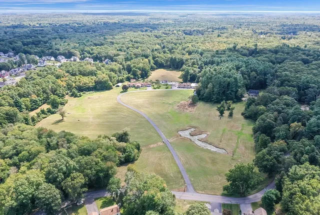 an aerial view of a house with a yard