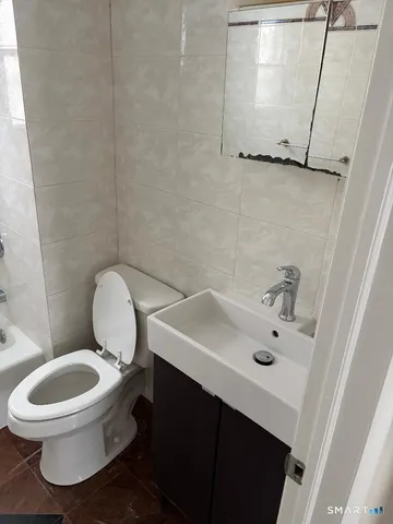 an empty room with wooden floor & closet area