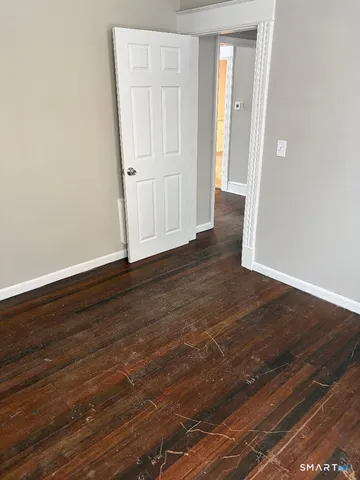 a view of a room with wooden floor and staircase