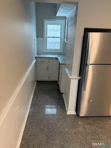 a view of hallway with stairs and a window