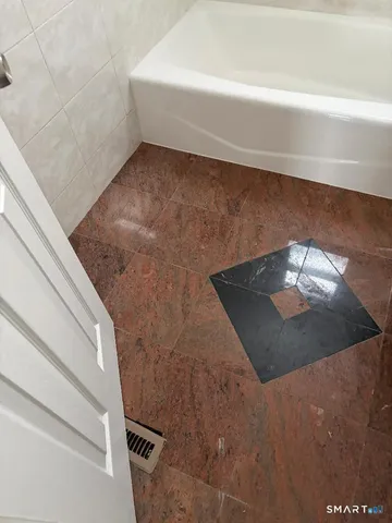 a white toilet sitting next to a bathroom sink