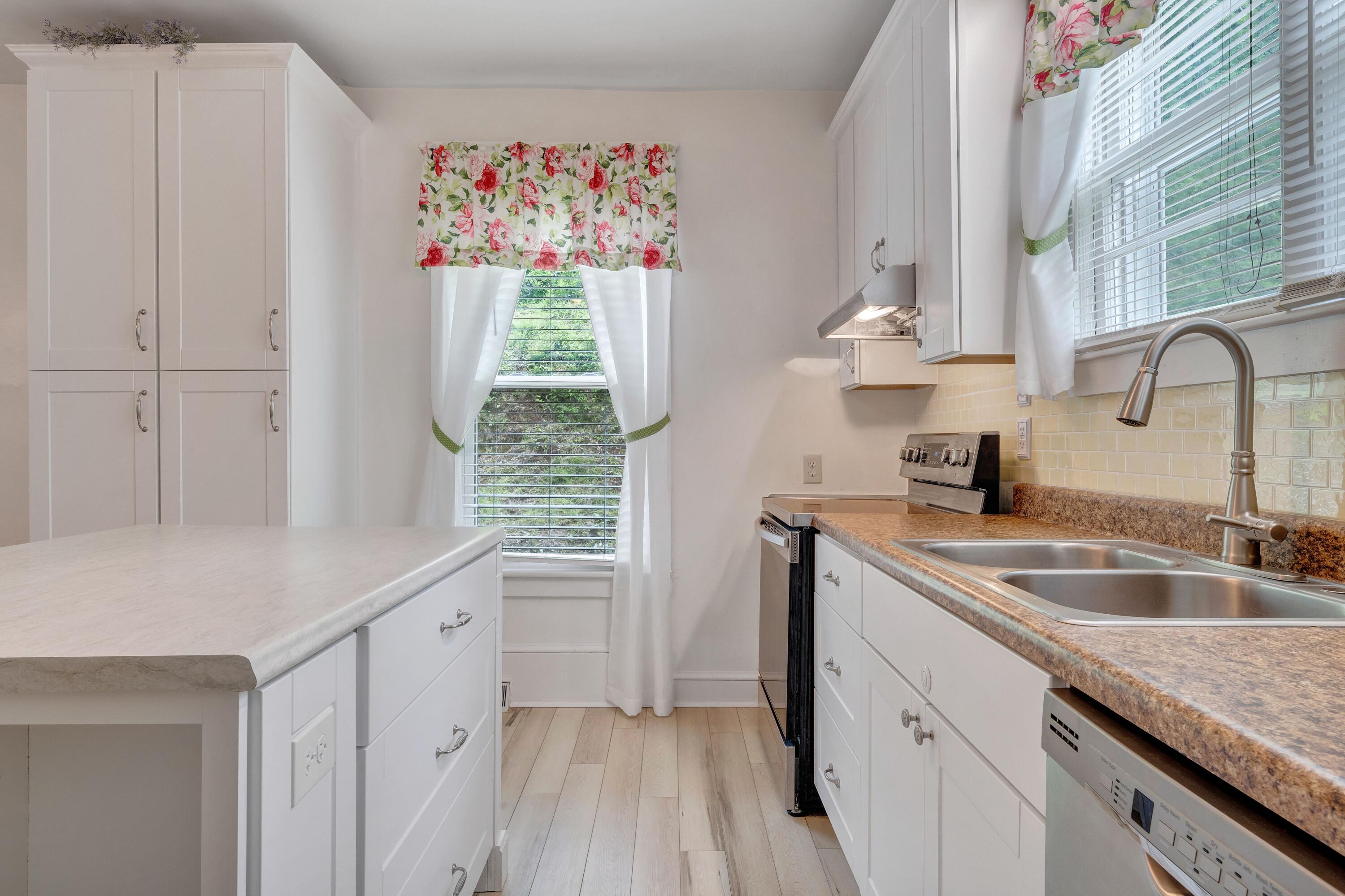 3759 Mill Iron Road Goodview, VA 24095 - Photo 14 of 39 a kitchen with granite countertop a sink dishwasher window and cabinets