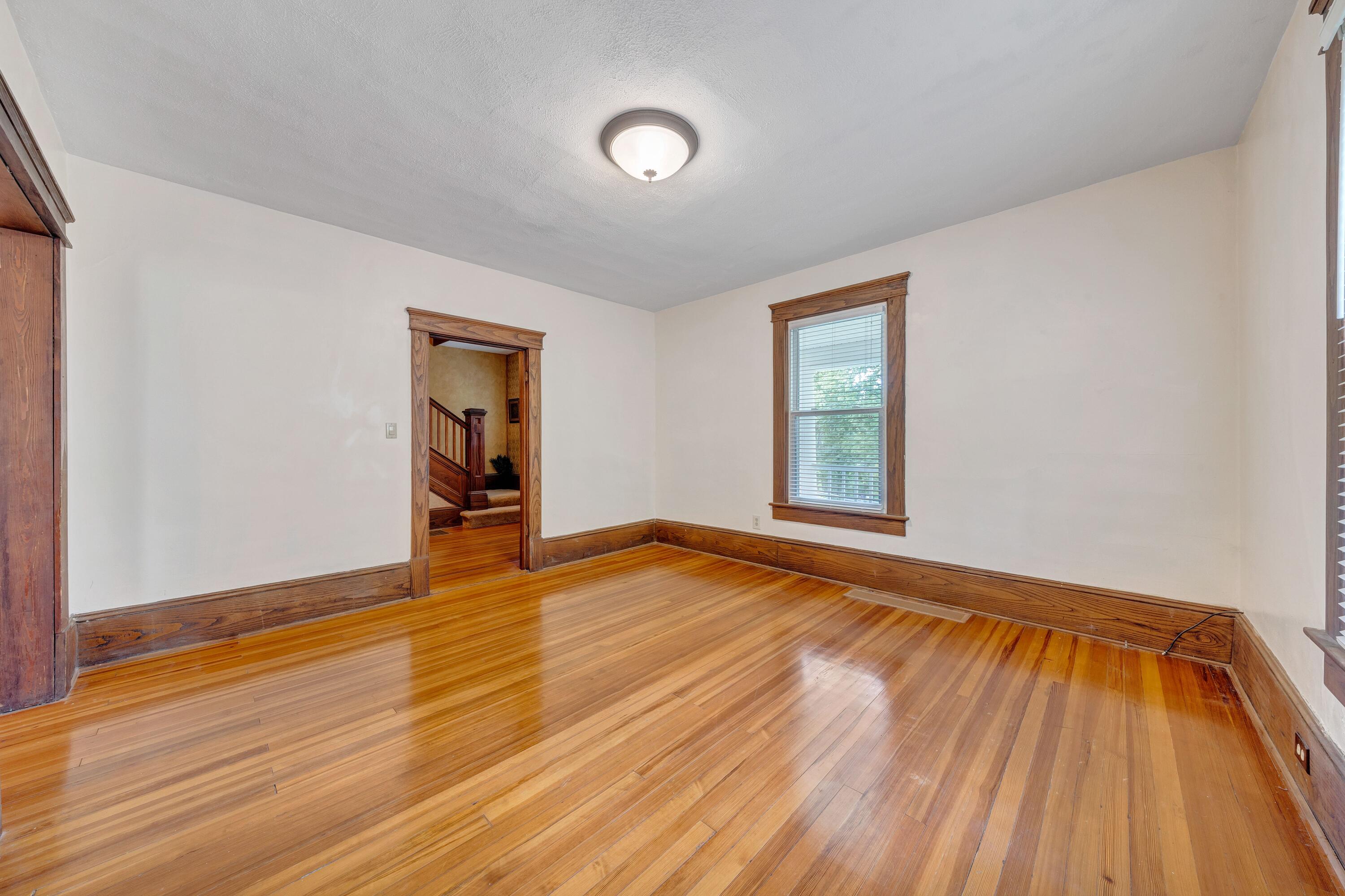 3759 Mill Iron Road Goodview, VA 24095 - Photo 18 of 39 a view of an empty room with wooden floor and a window