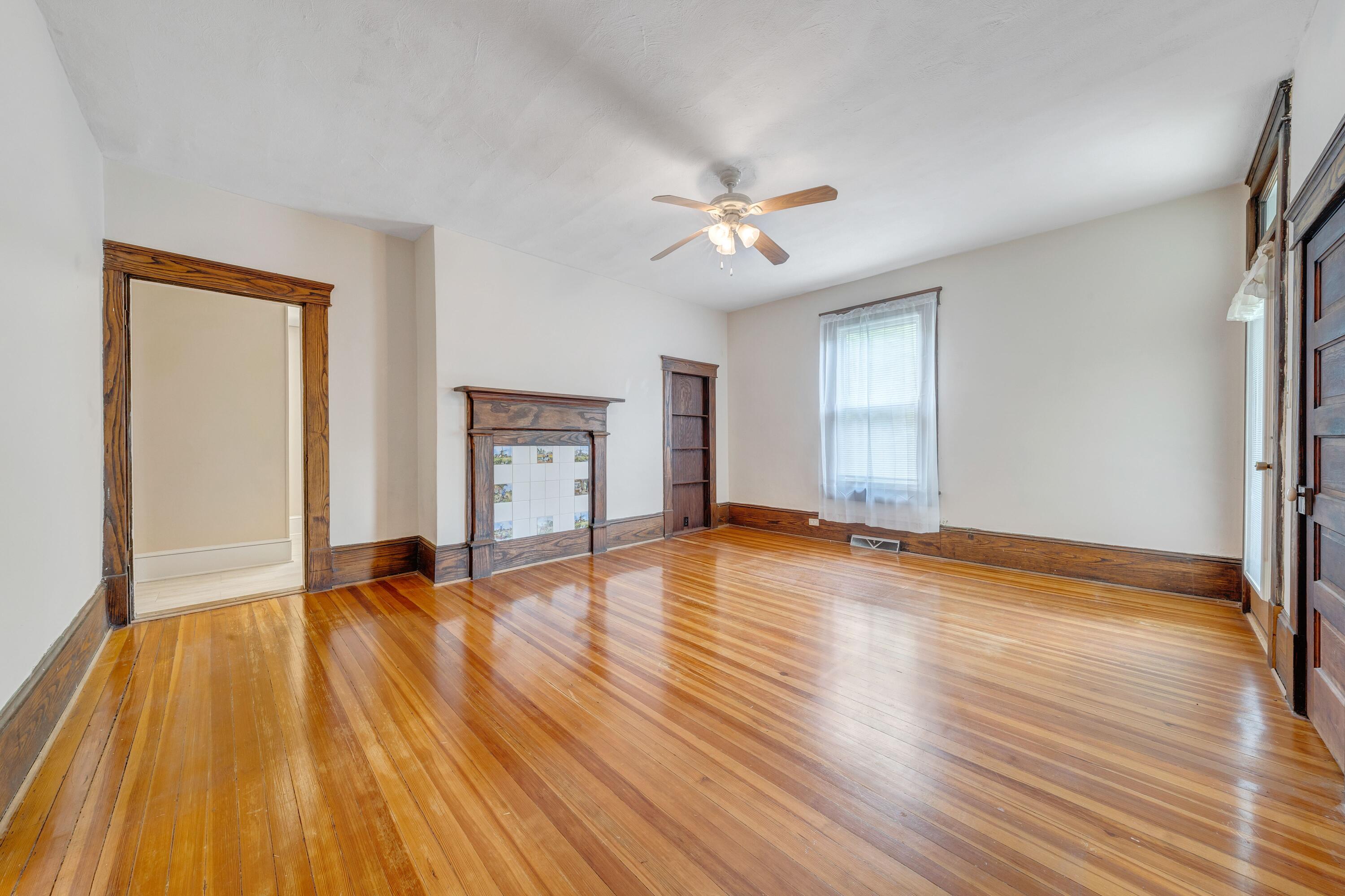 3759 Mill Iron Road Goodview, VA 24095 - Photo 8 of 39 a view of empty room with wooden floor and ceiling fan