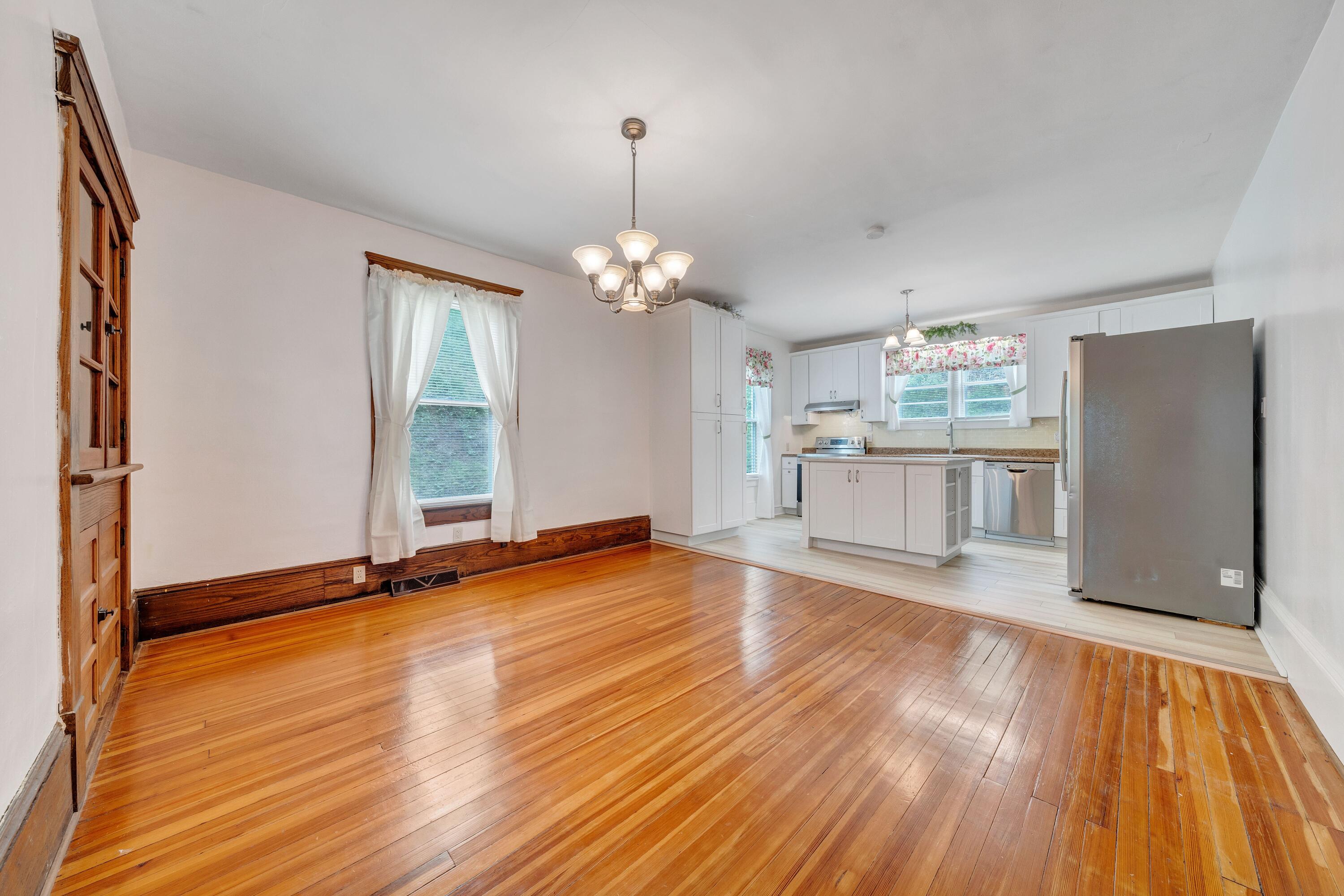 3759 Mill Iron Road Goodview, VA 24095 - Photo 10 of 39 a view of a kitchen with a dishwasher and wooden floor