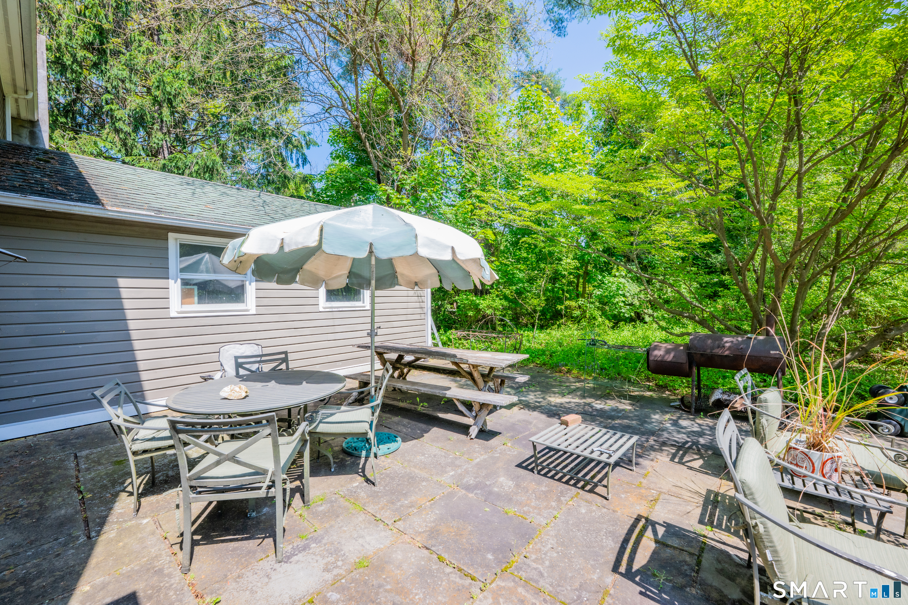 231 B Kent Road Kent, CT 06757 - Photo 20 of 35 a view of backyard with outdoor seating a patio and plants