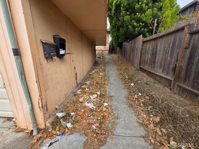 a view of a pathway with a backyard