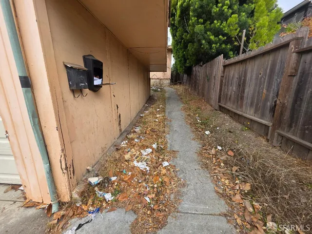 a view of a pathway with a backyard