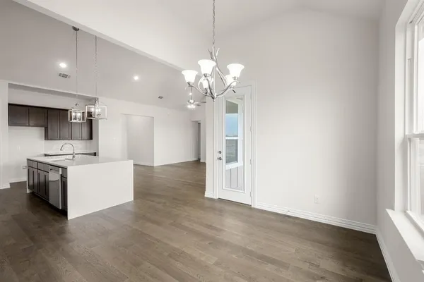 a view of a kitchen with a sink a refrigerator and a stove