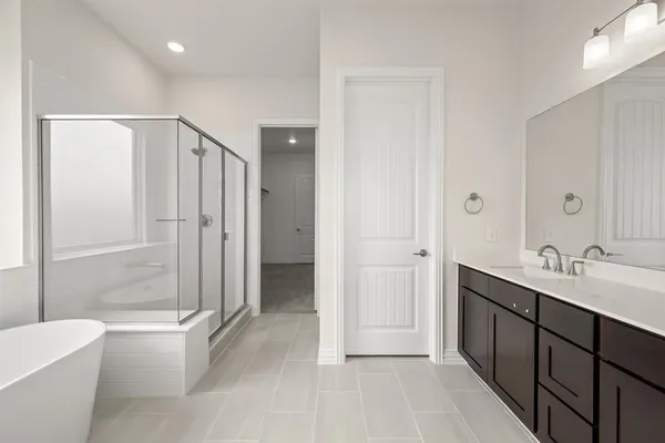 a bathroom with a double vanity sink toilet mirror and bathtub