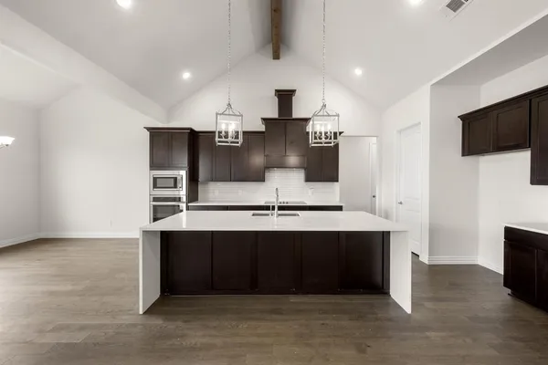 a view of kitchen with stainless steel appliances a sink and cabinets