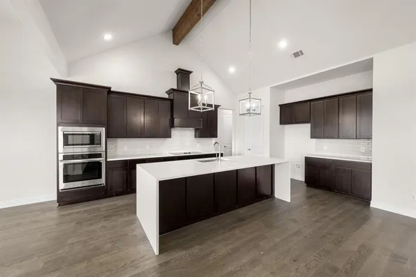 a kitchen with stainless steel appliances kitchen island granite countertop a stove and a refrigerator