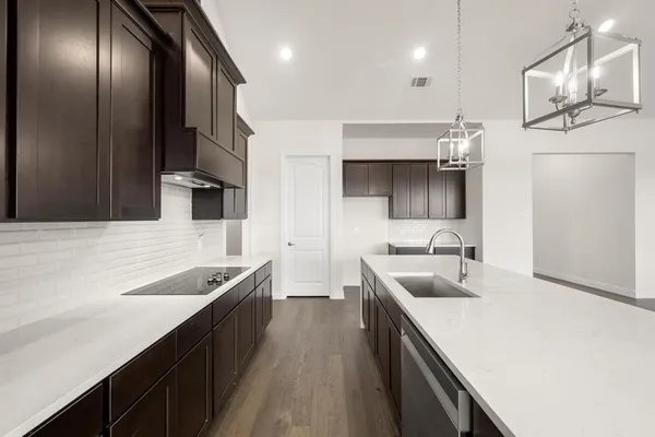 a kitchen with stainless steel appliances a sink stove and cabinets