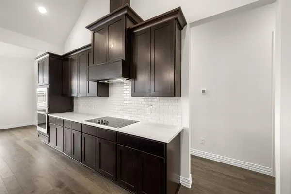 a kitchen with stainless steel appliances granite countertop a sink and a refrigerator