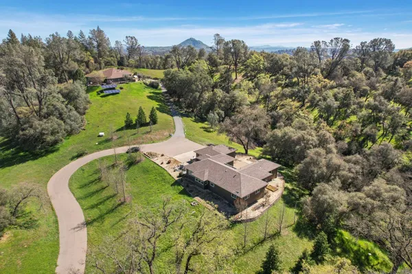 an aerial view of a house with mountain view