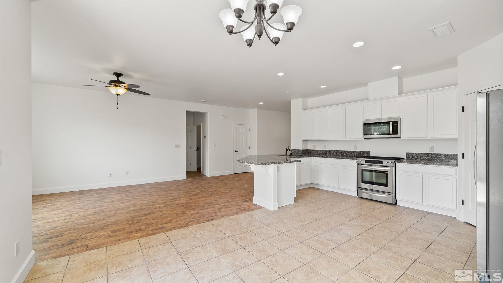 11074 Colton Drive Reno, NV 89521 - Photo 13 of 28 a view of kitchen with sink microwave and refrigerator