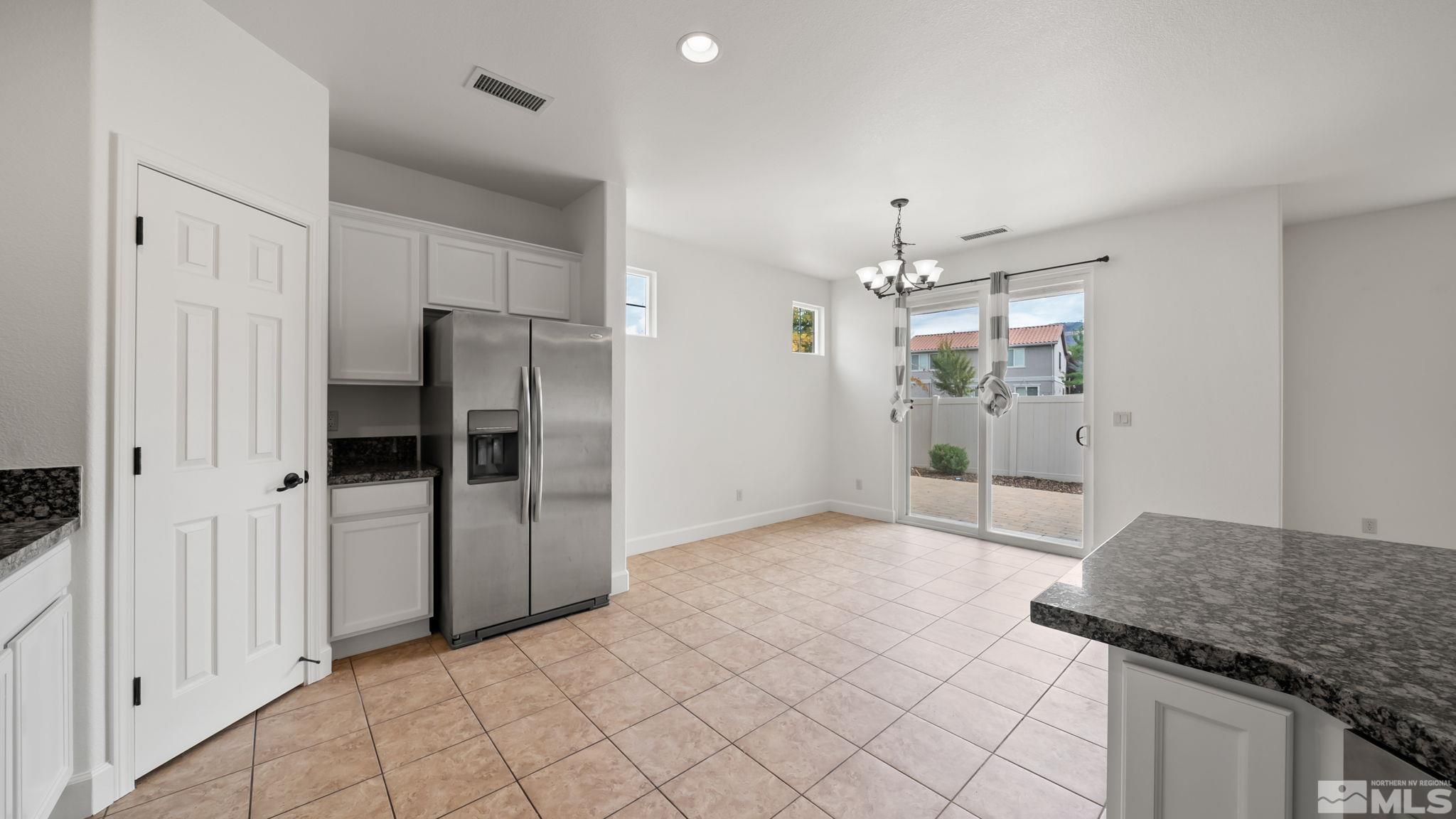 11074 Colton Drive Reno, NV 89521 - Photo 17 of 28 a view of a kitchen cabinets and chandelier