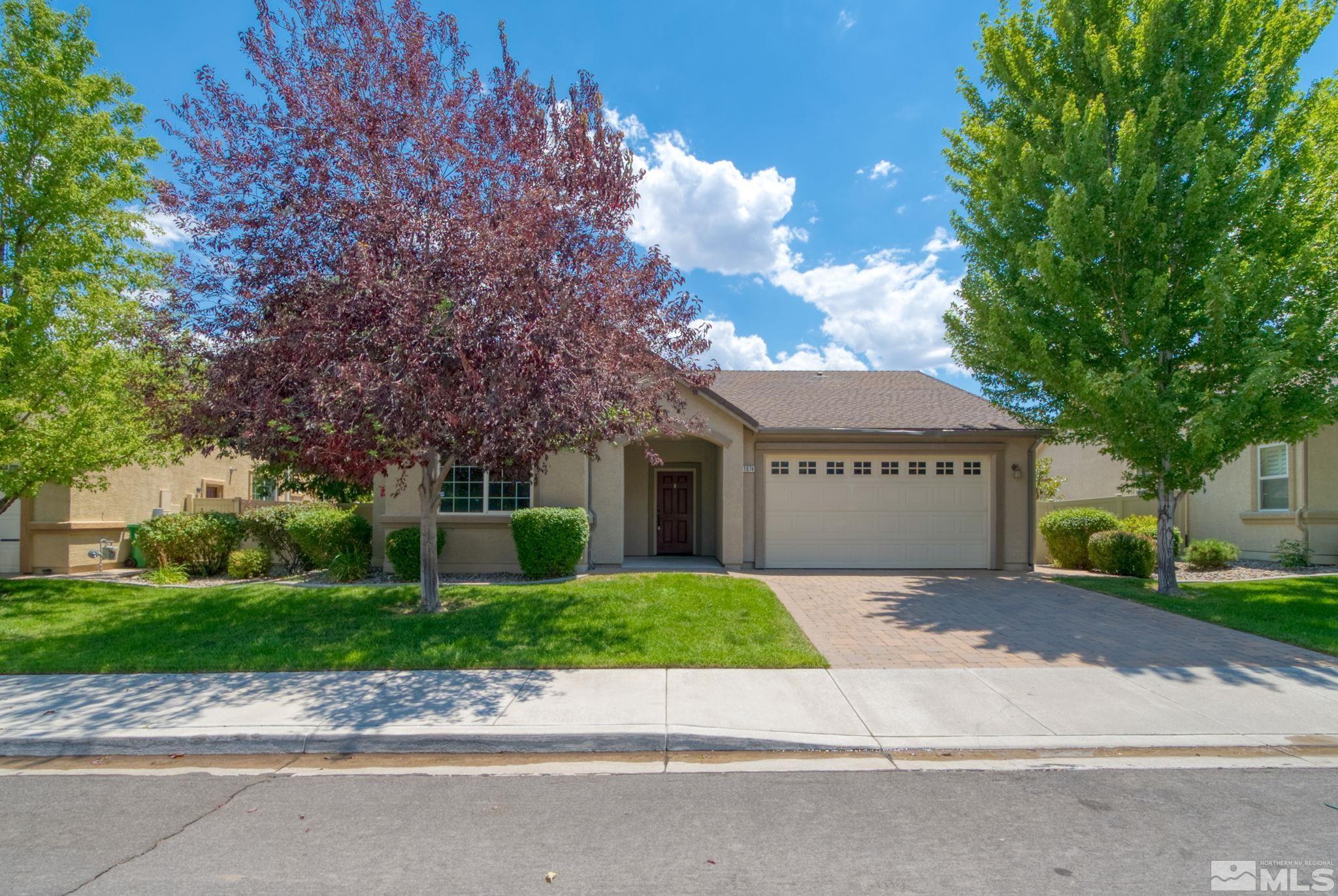 11074 Colton Drive Reno, NV 89521 - Photo 3 of 28 a front view of a house with a garden and trees