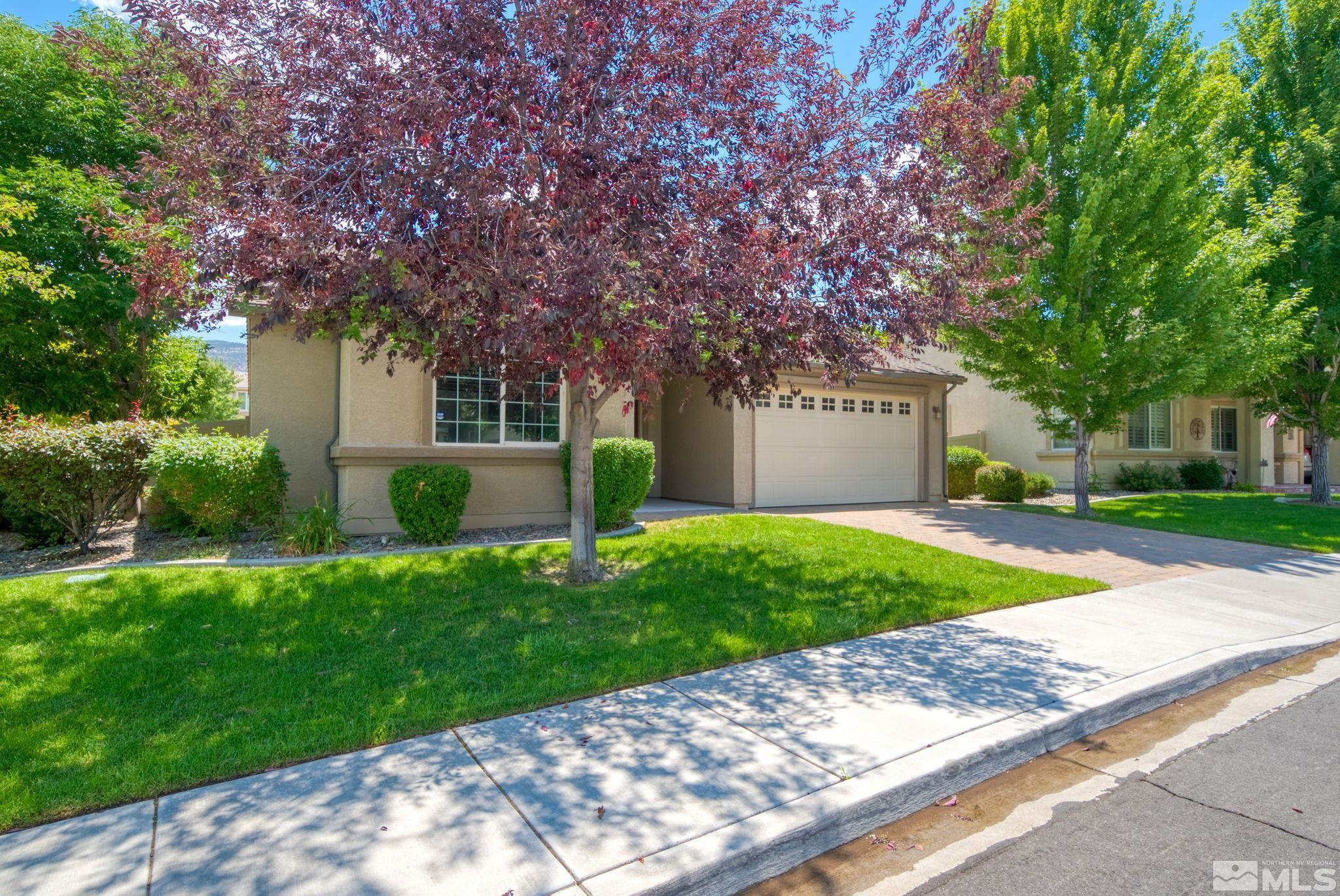 11074 Colton Drive Reno, NV 89521 - Photo 4 of 28 a front view of a house with a yard and garage