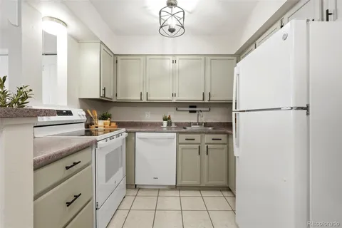a kitchen with appliances cabinets and a counter top space
